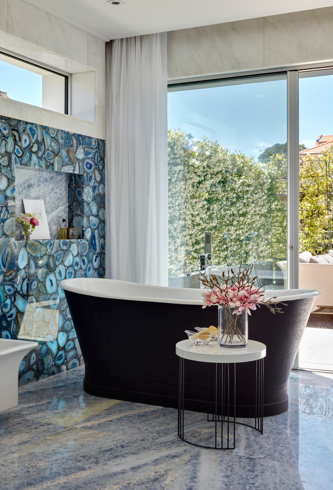 Foto di una stanza da bagno design con vasca freestanding e pareti blu