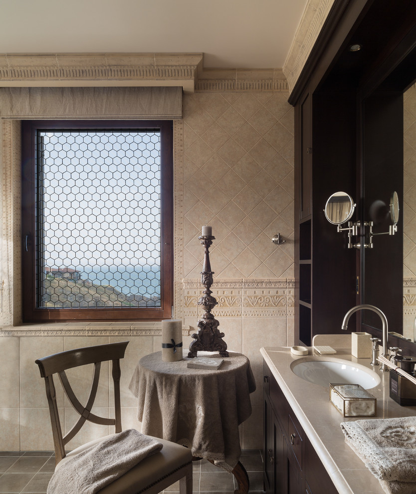 Inspiration for a mediterranean master beige tile bathroom remodel in Moscow with dark wood cabinets and an undermount sink