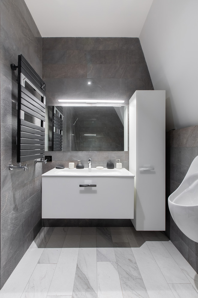 Bathroom - mid-sized scandinavian master gray tile and porcelain tile porcelain tile and white floor bathroom idea in Saint Petersburg with flat-panel cabinets, white cabinets, an undermount tub, a wall-mount toilet, white walls and a drop-in sink