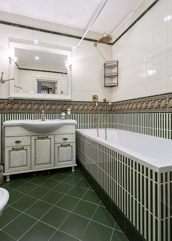 Inspiration for a traditional ensuite bathroom in Moscow with raised-panel cabinets, distressed cabinets, white tiles, green tiles, a built-in bath, a shower/bath combination, multi-coloured walls, a built-in sink and a shower curtain.