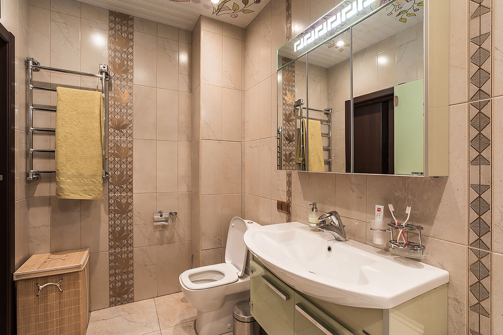 Design ideas for a medium sized contemporary ensuite bathroom in Saint Petersburg with glass-front cabinets, beige cabinets, an alcove bath, a one-piece toilet, beige tiles, ceramic tiles, beige walls, porcelain flooring, a wall-mounted sink and beige floors.