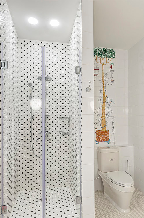 This is an example of a classic family bathroom in Moscow with an alcove shower, a two-piece toilet, white walls, raised-panel cabinets, white cabinets, a freestanding bath, black and white tiles, ceramic tiles, mosaic tile flooring, a submerged sink and marble worktops.