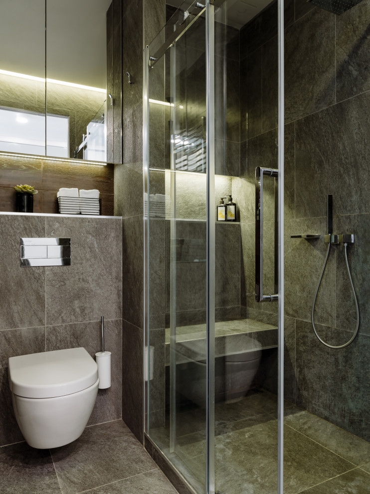 Design ideas for a medium sized contemporary bathroom in Moscow with glass-front cabinets, grey cabinets, a wall mounted toilet, grey tiles, ceramic tiles, grey walls, grey floors, a sliding door, grey worktops, ceramic flooring, a console sink and engineered stone worktops.