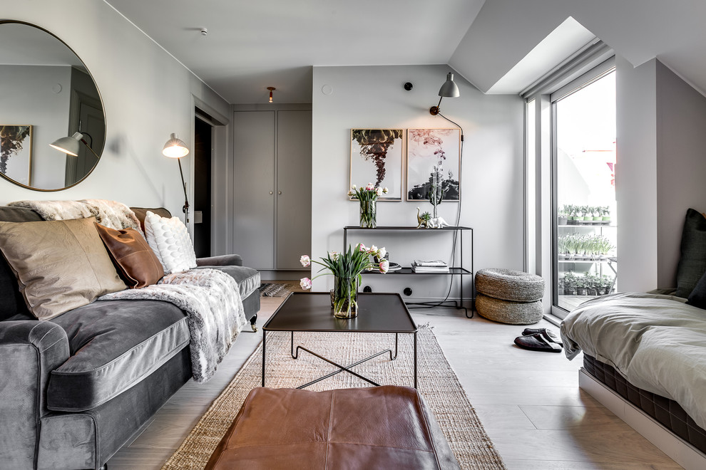 Источник вдохновения для домашнего уюта: изолированная гостиная комната среднего размера в скандинавском стиле с серыми стенами и полом из ламината