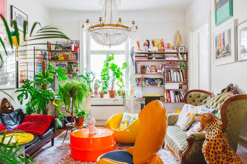 Example of a mid-sized eclectic formal light wood floor living room design in Stockholm with white walls