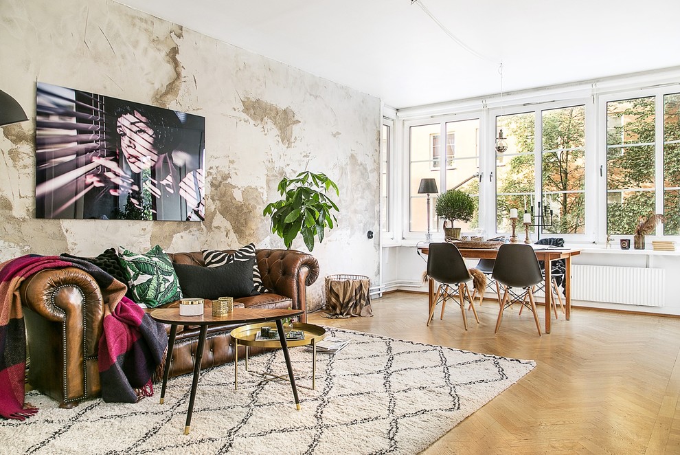 Inspiration for an expansive scandi formal open plan living room feature wall in Stockholm with light hardwood flooring, no fireplace, no tv and beige walls.