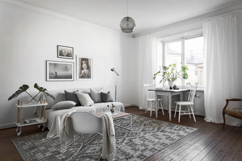Esempio di un soggiorno scandinavo aperto con pareti bianche e parquet scuro
