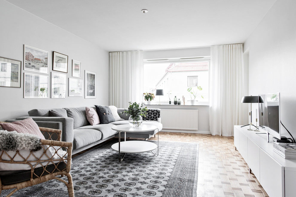 Living room - scandinavian enclosed light wood floor and beige floor living room idea in Gothenburg with white walls, no fireplace and a tv stand