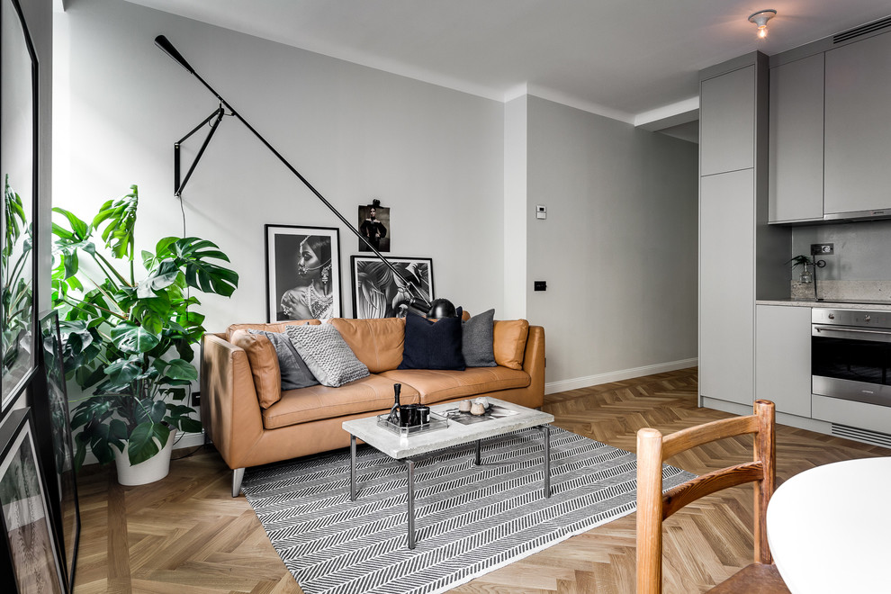 Medium sized scandi formal living room in Stockholm with grey walls, light hardwood flooring, no fireplace and no tv.