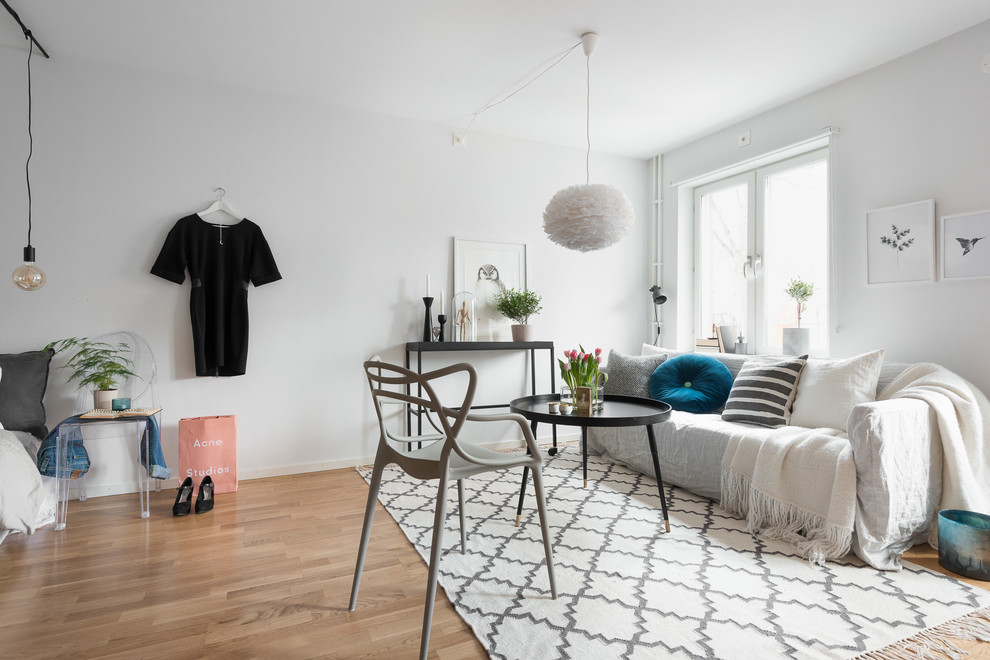 Inspiration for a medium sized scandinavian open plan living room in Gothenburg with white walls, medium hardwood flooring, no fireplace and no tv.