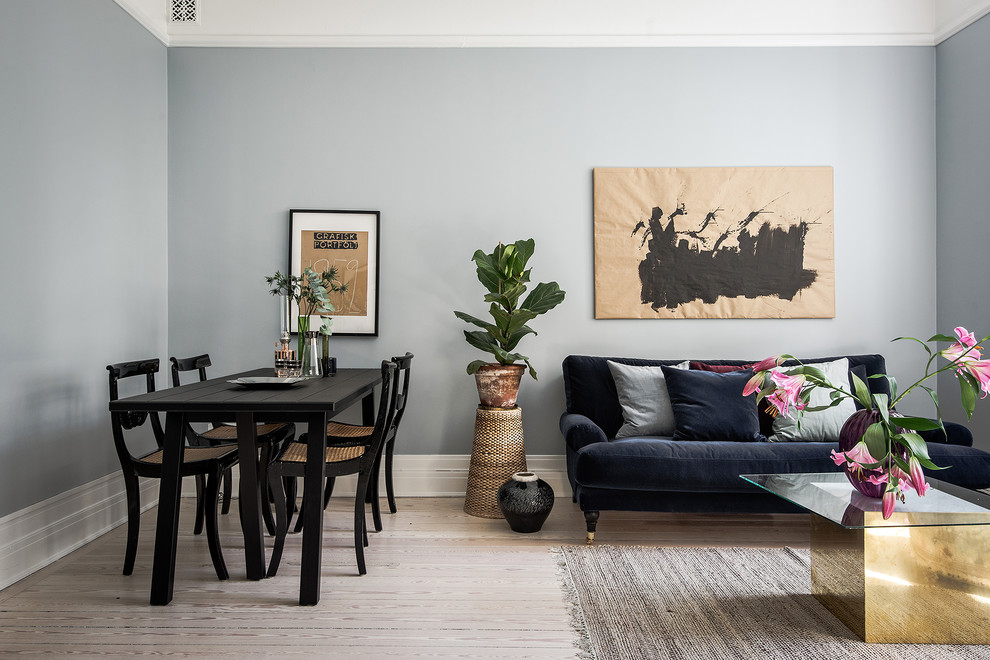Photo of a medium sized scandi open plan living room in Stockholm with blue walls and light hardwood flooring.