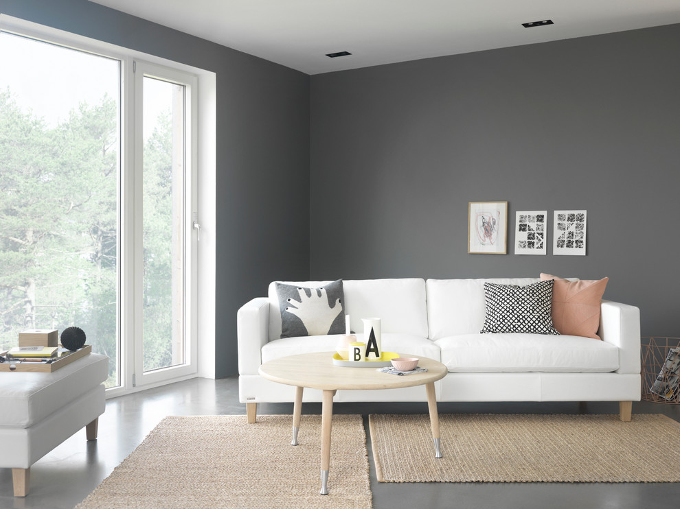 Esempio di un soggiorno scandinavo di medie dimensioni e aperto con pareti grigie, pavimento in cemento e nessuna TV
