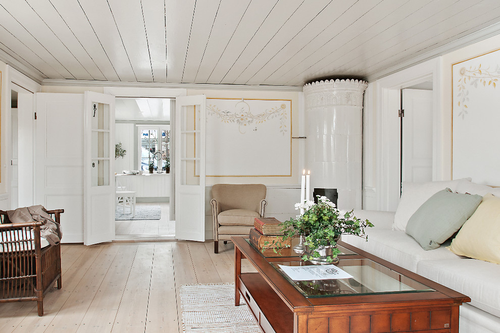 Mid-sized farmhouse formal and open concept light wood floor living room photo in Gothenburg with white walls, a corner fireplace, a tile fireplace and no tv
