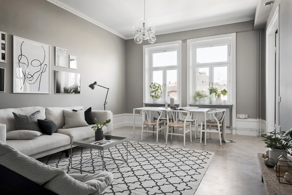 Abgetrenntes Skandinavisches Wohnzimmer ohne Kamin mit grauer Wandfarbe, Betonboden und grauem Boden in Stockholm