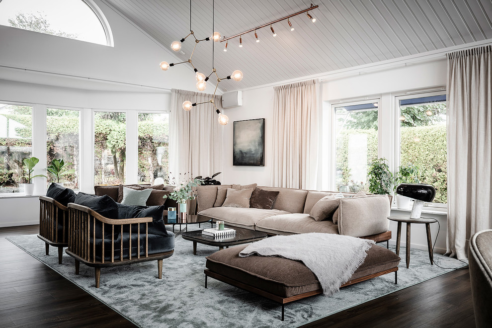 Example of a large danish formal and open concept dark wood floor and brown floor living room design in Gothenburg with white walls