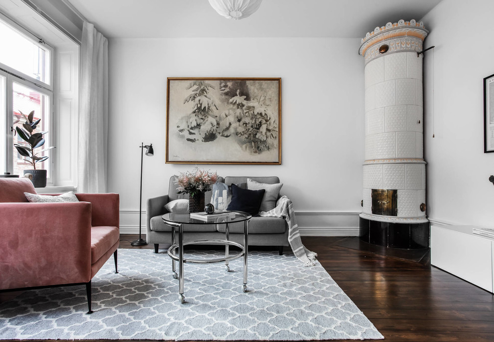 Living room - scandinavian dark wood floor and brown floor living room idea in Stockholm with white walls and a corner fireplace