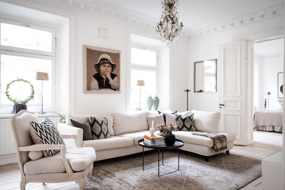 Mid-sized danish enclosed light wood floor and beige floor living room photo in Gothenburg with white walls
