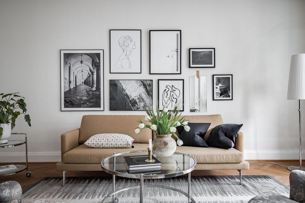 Photo of a medium sized scandinavian formal and grey and cream enclosed living room in Gothenburg with white walls, medium hardwood flooring and brown floors.