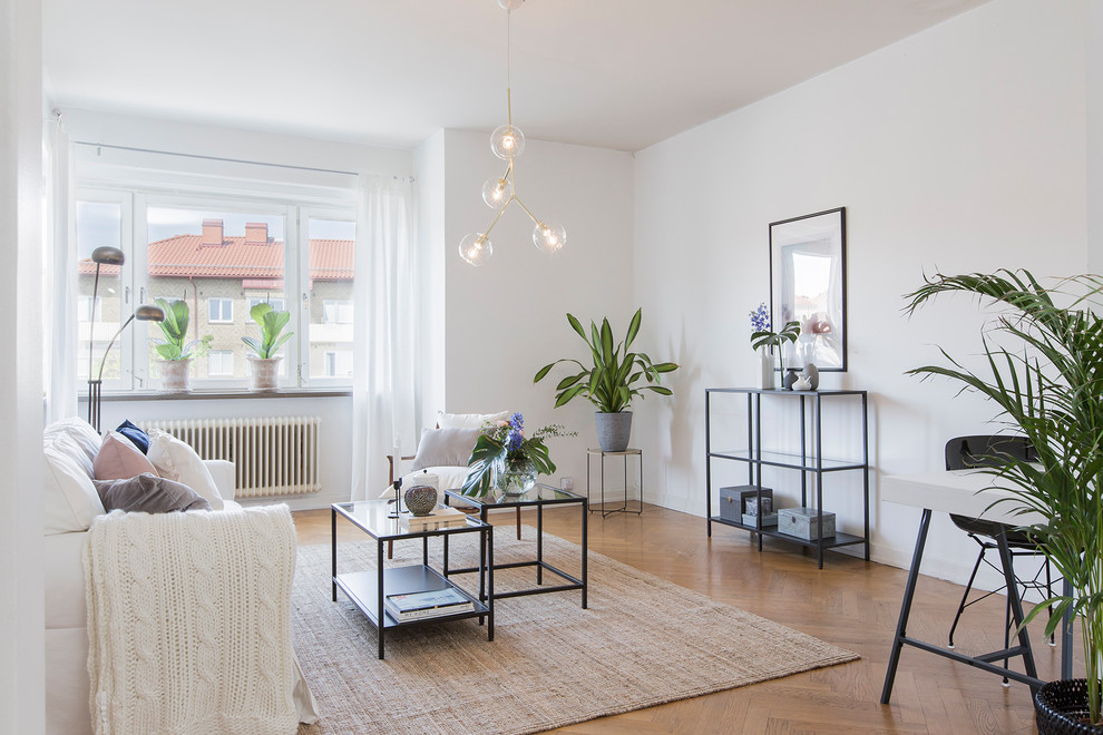 Scandi formal enclosed living room in Malmo with white walls, medium hardwood flooring, no tv and beige floors.