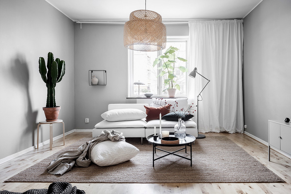 Photo of a medium sized scandi enclosed living room in Gothenburg with grey walls, light hardwood flooring and beige floors.