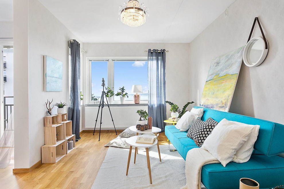 Inspiration for a mid-sized scandinavian open concept and formal medium tone wood floor living room remodel in Gothenburg with no tv, gray walls and no fireplace