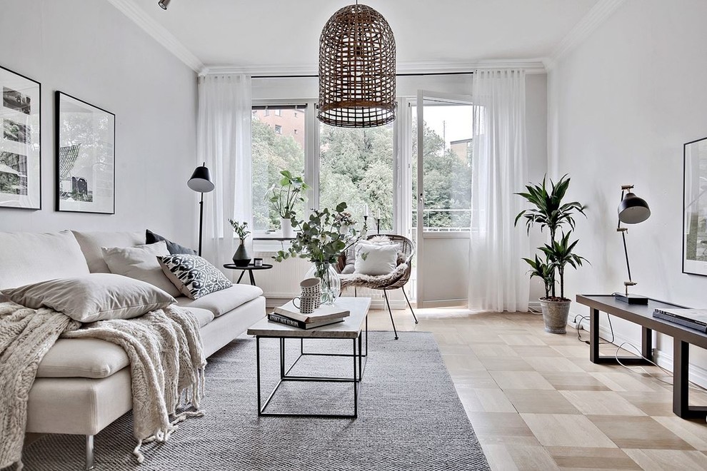 Medium sized scandinavian formal living room in Gothenburg with grey walls, light hardwood flooring, no tv and feature lighting.