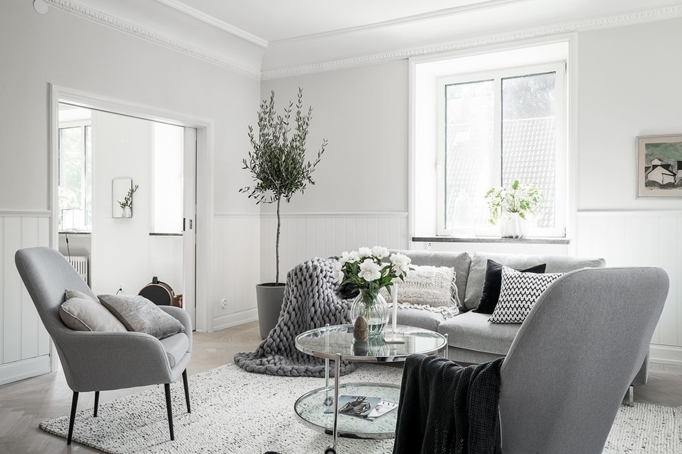 Living room - mid-sized scandinavian light wood floor and beige floor living room idea in Gothenburg with white walls