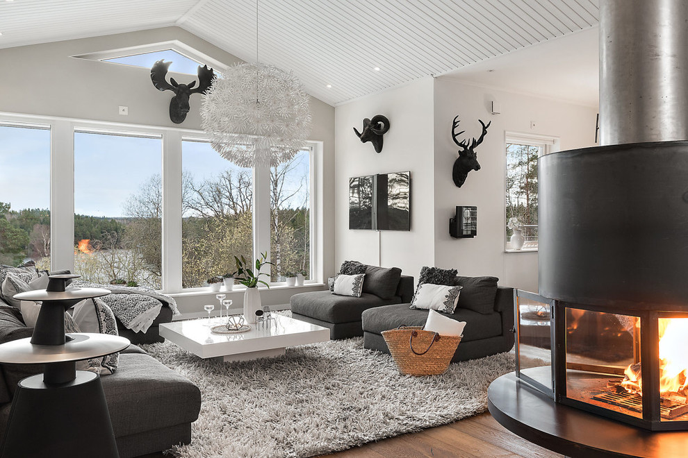 Medium sized scandi formal open plan living room in Stockholm with white walls, dark hardwood flooring and a corner fireplace.