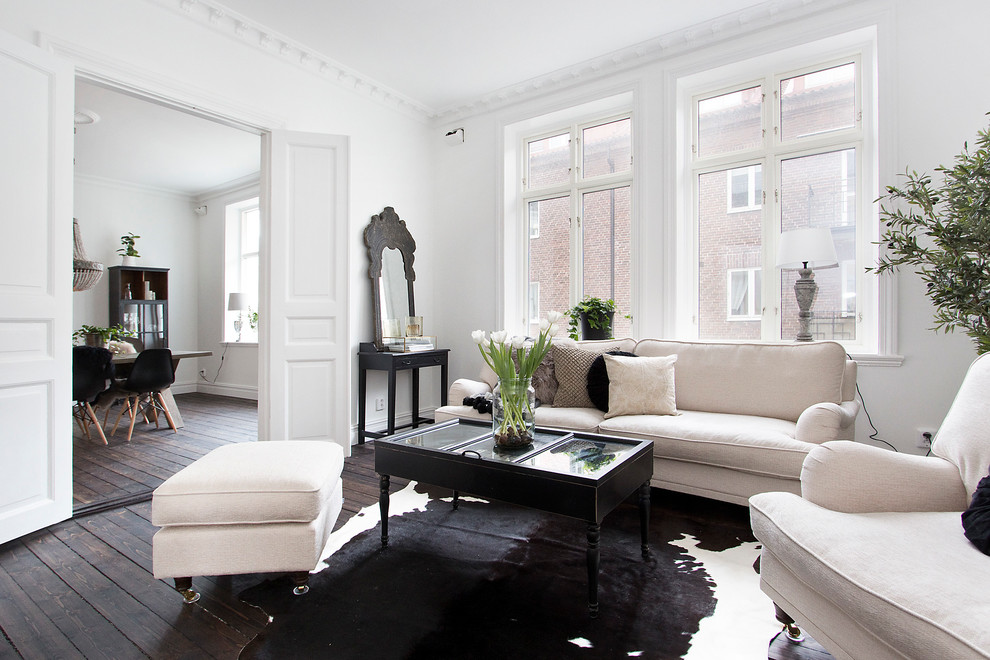 Example of a large danish formal and open concept dark wood floor living room design in Malmo with white walls, no fireplace and no tv