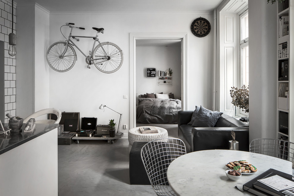 Ispirazione per un soggiorno scandinavo aperto con pareti bianche e pavimento in cemento