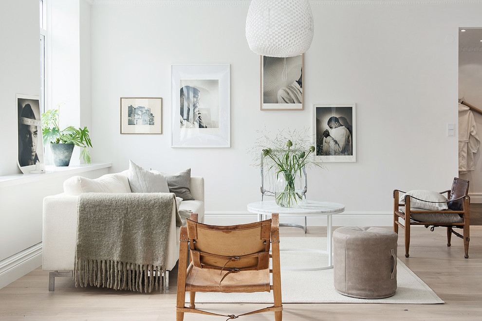 Medium sized scandinavian formal living room in Gothenburg with white walls, light hardwood flooring, no fireplace and no tv.