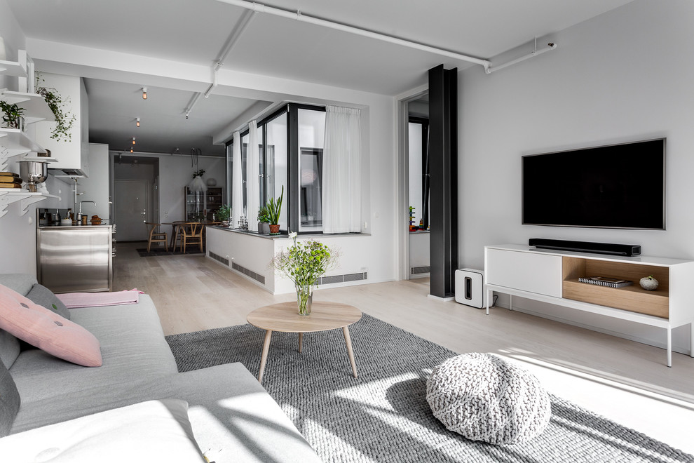 Design ideas for a medium sized modern living room in Stockholm with grey walls and light hardwood flooring.