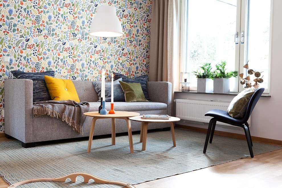 Inspiration for a scandinavian formal enclosed living room in Gothenburg with multi-coloured walls, medium hardwood flooring, no tv, no fireplace and brown floors.