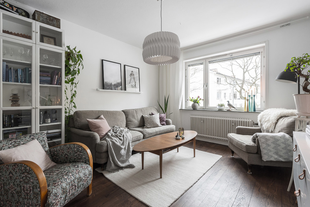 Photo of a medium sized scandi living room in Stockholm with white walls, dark hardwood flooring, a reading nook and no fireplace.