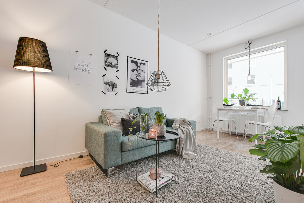 Medium sized scandinavian formal living room in Stockholm with white walls, light hardwood flooring and no tv.