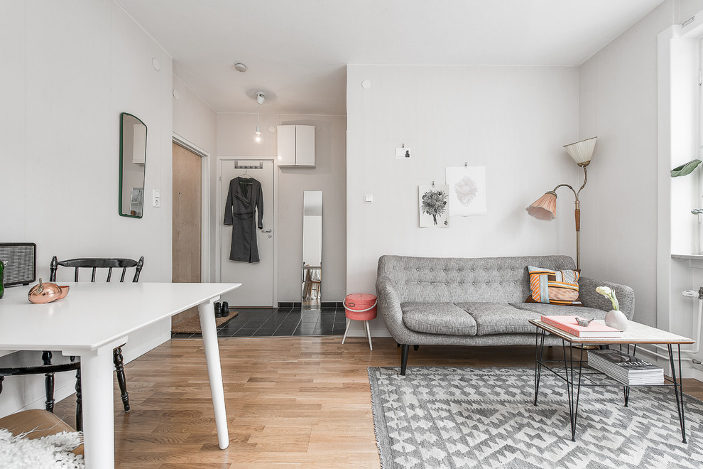 Ejemplo de salón para visitas abierto escandinavo de tamaño medio sin televisor con paredes blancas y suelo de madera en tonos medios