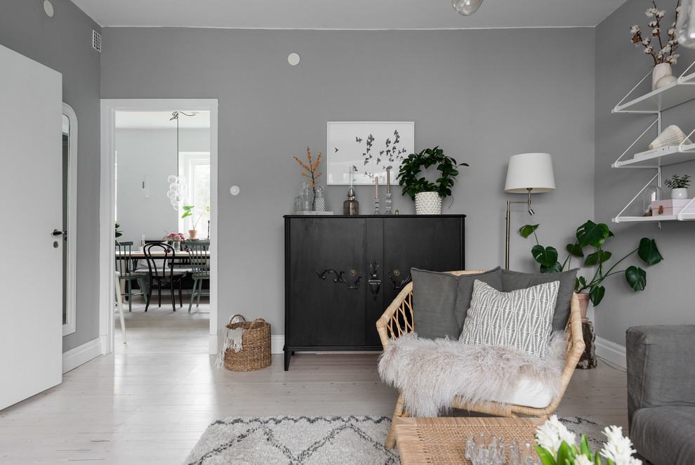 Inspiration for a mid-sized scandinavian enclosed light wood floor and white floor living room remodel in Gothenburg with gray walls