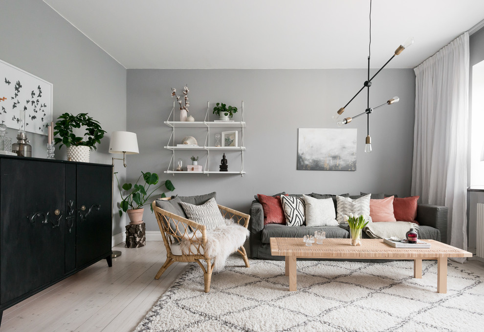 Living room - mid-sized scandinavian enclosed light wood floor and beige floor living room idea in Gothenburg with gray walls