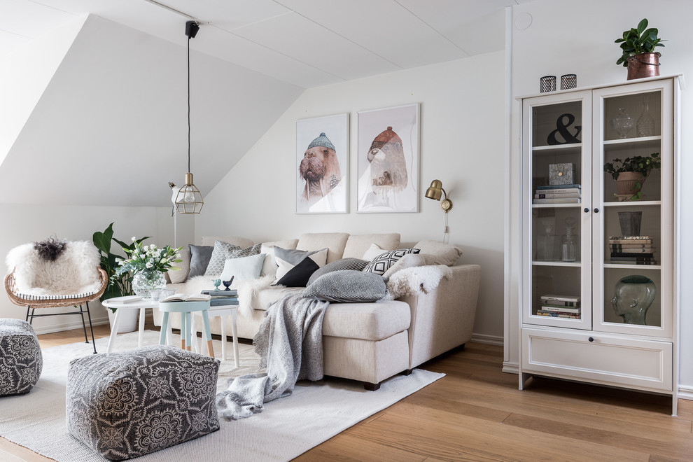 Exemple d'un salon scandinave ouvert avec un mur blanc et un sol en bois brun.