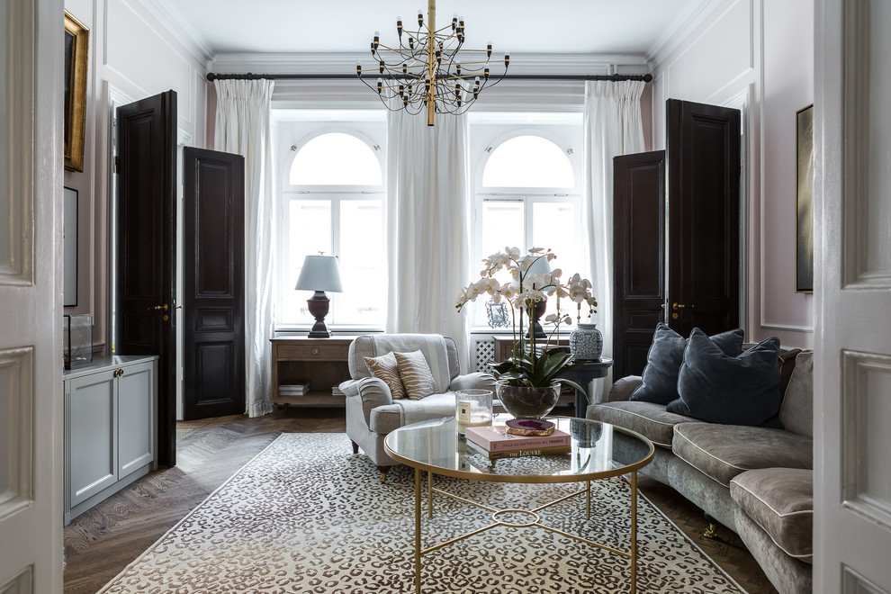 This is an example of a medium sized traditional formal enclosed living room in Stockholm with white walls, dark hardwood flooring, no fireplace and no tv.