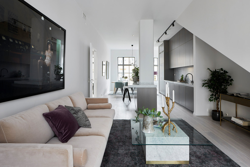 Living room - scandinavian open concept gray floor living room idea in Stockholm with white walls