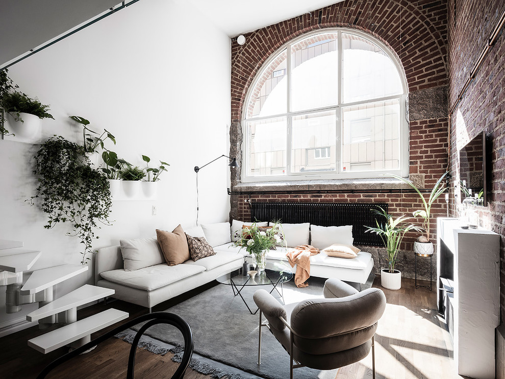 Inspiration for a medium sized scandi open plan living room in Gothenburg with multi-coloured walls, medium hardwood flooring, brown floors and a wall mounted tv.