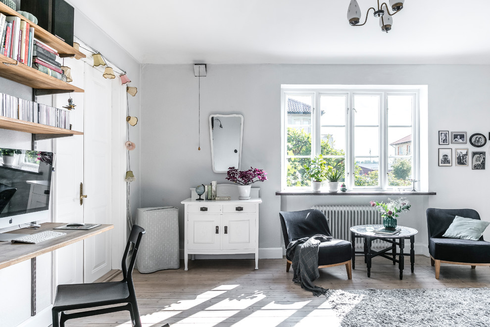 На фото: гостиная комната в скандинавском стиле с серыми стенами
