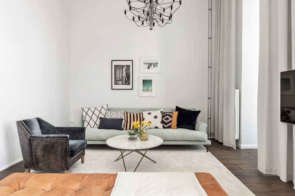 Offenes, Mittelgroßes, Repräsentatives Nordisches Wohnzimmer mit weißer Wandfarbe, dunklem Holzboden und TV-Wand in Stockholm
