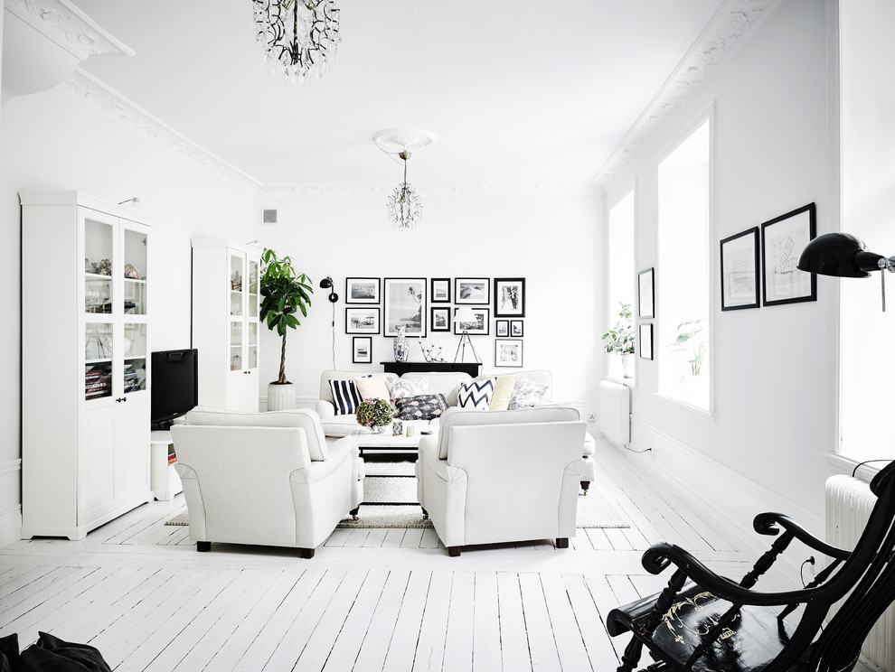 Photo of a medium sized scandi formal enclosed living room in Gothenburg with white walls, painted wood flooring, no fireplace and no tv.