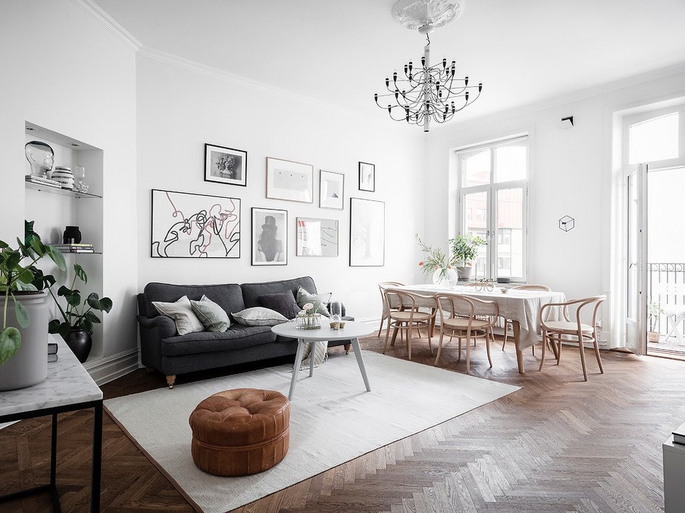 Immagine di un soggiorno scandinavo di medie dimensioni e aperto con pareti bianche, pavimento in legno massello medio, sala formale e pavimento marrone