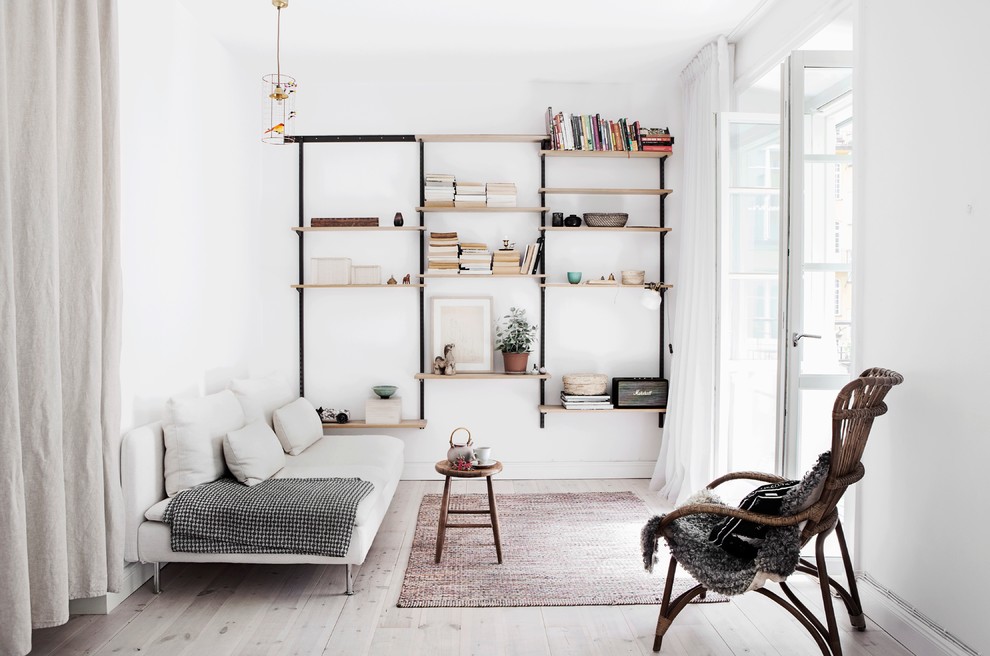 Living room - large scandinavian formal and open concept light wood floor living room idea in Stockholm with white walls, no fireplace and no tv