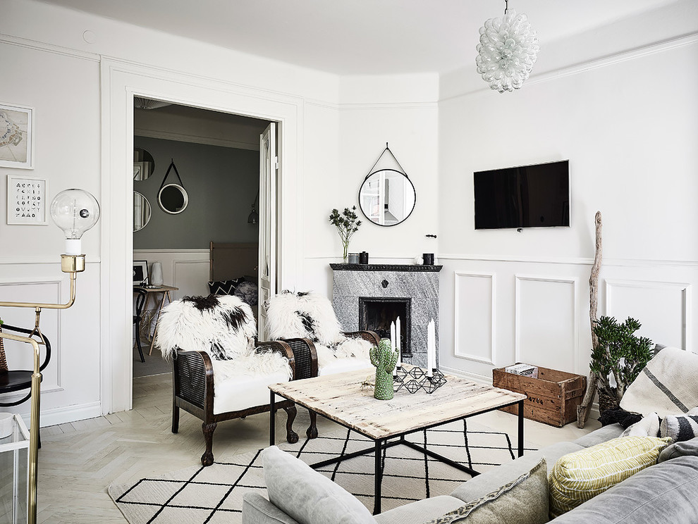 Photo of a medium sized scandi formal enclosed living room in Gothenburg with white walls, light hardwood flooring, a corner fireplace and a wall mounted tv.