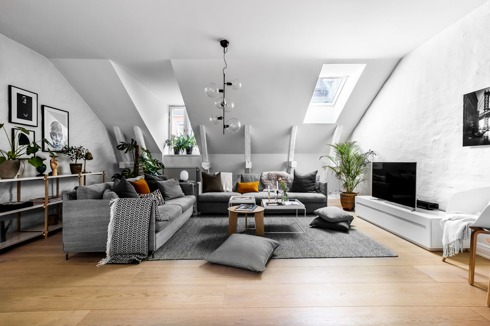 Diseño de salón abierto escandinavo sin chimenea con paredes blancas y televisor independiente