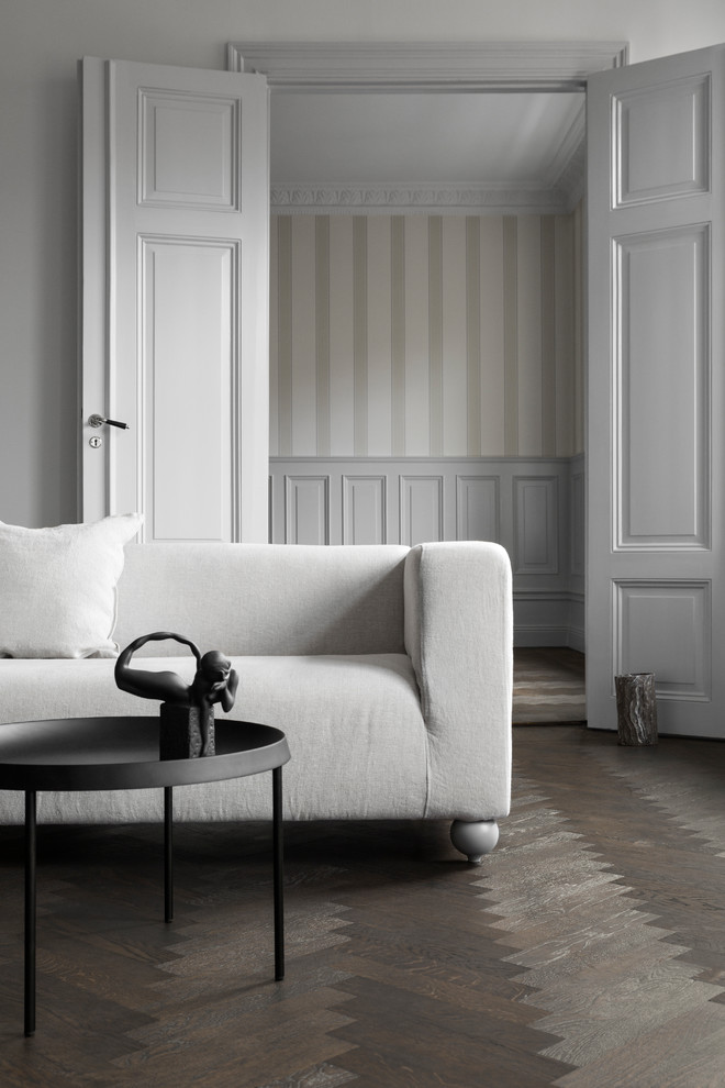 Living room - large scandinavian dark wood floor and brown floor living room idea in Other with gray walls